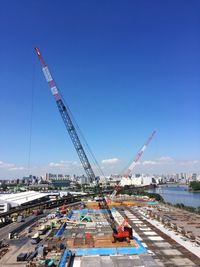 Cranes at construction site against sky