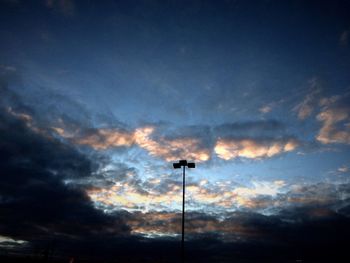 Low angle view of street light against cloudy sky