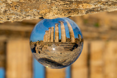 Close-up photo of an ancient acropolis through a glas lensball