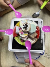 High angle view of woman holding ice cream on table