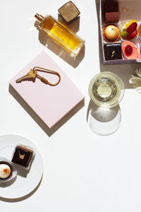 Overhead still life of chocolates, perfume, accessories
