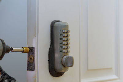 Close-up of man repairing door