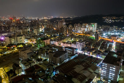 High angle view of city lit up at night