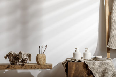 Close-up of objects on table against wall at home