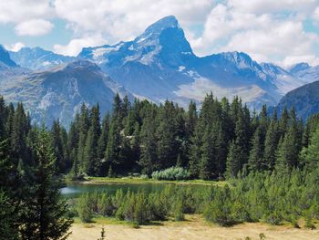 Scenic view of mountains against cloudy sky