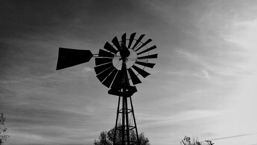 Low angle view of ferris wheel against sky