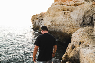 Rear view of man looking at sea