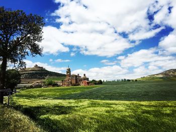 Scenic view of trees and buildings against sky