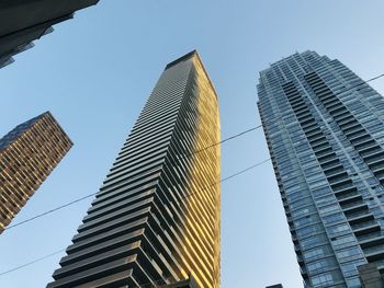 Low angle view of modern buildings against clear sky tower building craper trio colors upper