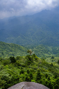 Scenic view of mountains against cloudy sky