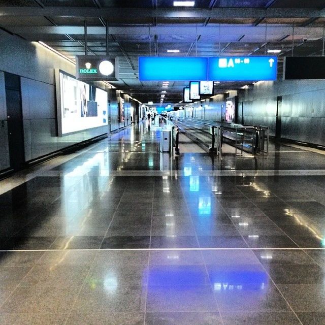 indoors, illuminated, subway station, ceiling, transportation, railroad station, subway, public transportation, lighting equipment, modern, flooring, railroad station platform, built structure, interior, airport, architecture, communication, transportation building - type of building, night, tiled floor