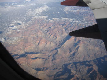 Aerial view of landscape seen through airplane window