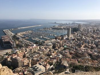 High angle view of buildings and sea against sky