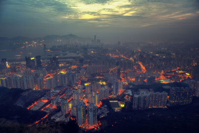 High angle view of illuminated cityscape against sky at dusk