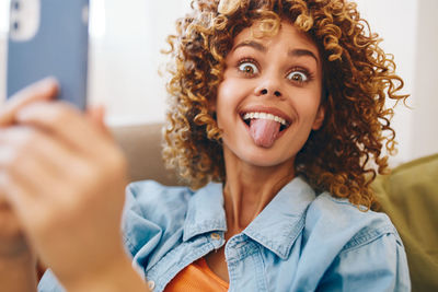 Portrait of young woman using mobile phone