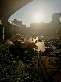 High angle view of buildings in city against bright sun