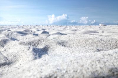 Close-up of sand on beach against sky