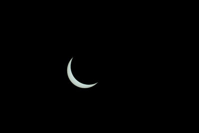 Low angle view of half moon against sky at night