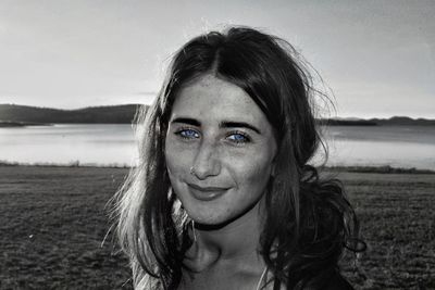 Portrait of smiling young woman at beach