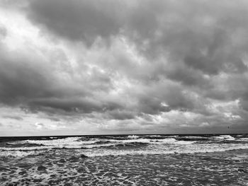 Scenic view of sea against cloudy sky