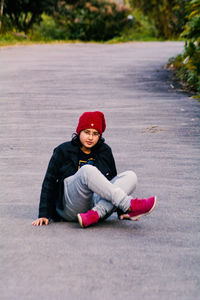 Portrait of boy sitting on road