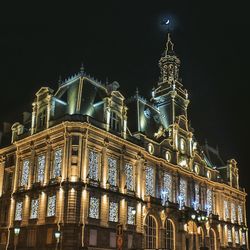 Low angle view of illuminated building at night