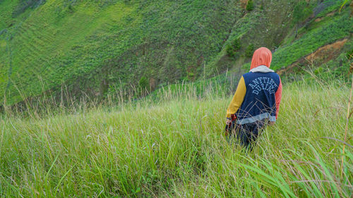 Rear view of woman walking in farm