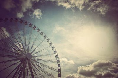 Low angle view of ferris wheel against sky