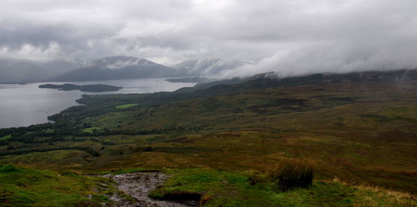 Scenic view of mountains against cloudy sky