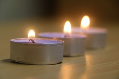 Close-up of tea light candles on table