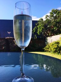 Close-up of beer glass on table against clear sky