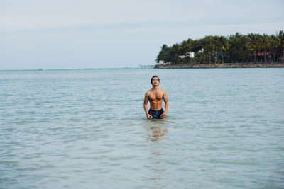 Rear view of woman swimming in sea