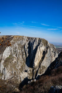 Rock formations on landscape against blue sky