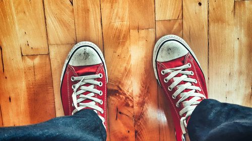 Low section of people standing on tiled floor