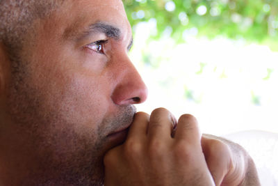 Close-up portrait of man with hand