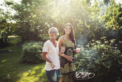 Portrait of a smiling young woman holding plants