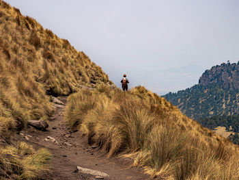 Panoramic view of man on mountain against sky