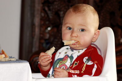 Portrait of cute baby girl sitting on table