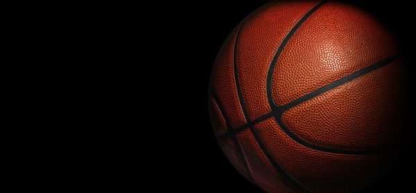 Close-up of basketball hoop in the dark