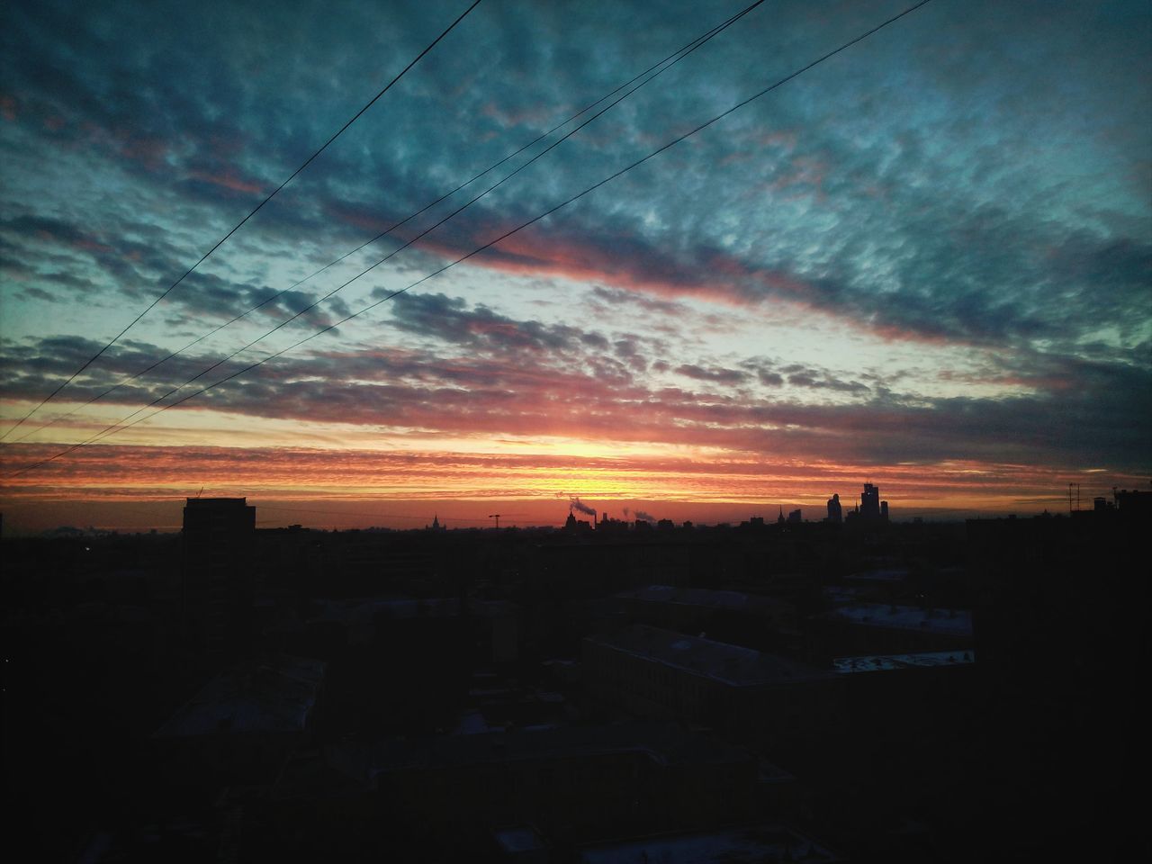 sunset, sky, silhouette, cloud - sky, building exterior, architecture, built structure, orange color, cloudy, dramatic sky, cloud, scenics, beauty in nature, dusk, nature, dark, landscape, city, moody sky, outdoors