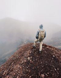 Rear view of man walking on a volcano