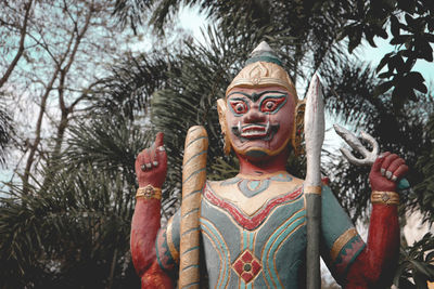 Statue of buddha against trees