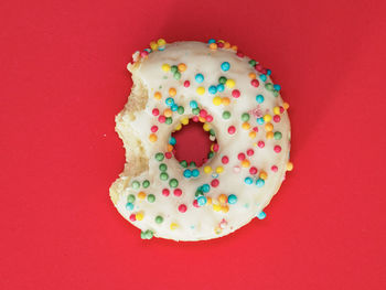 Directly above shot of donut on yellow background