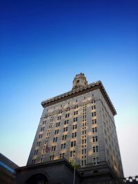 Low angle view of building against clear blue sky
