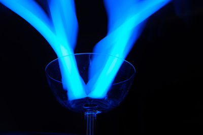 Close-up of illuminated lamp against black background