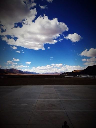 AIRPORT RUNWAY AGAINST SKY