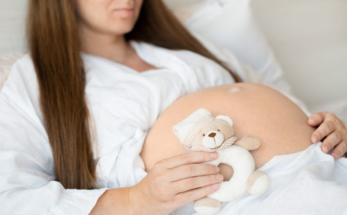Midsection of woman holding dental clinic