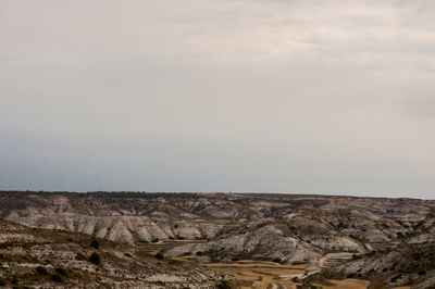 Scenic view of arid landscape against sky