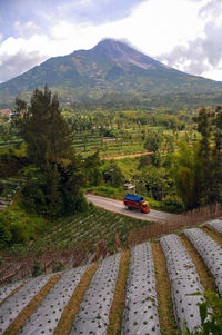 Scenic view of land and mountains against sky