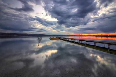 Bridge over sea against sky during sunset